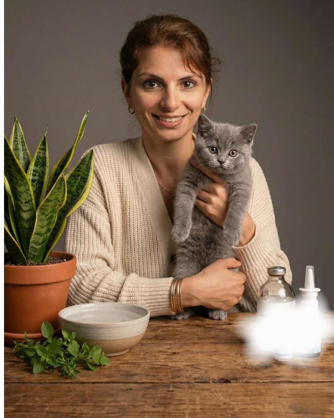 A person holding a cat indoors while using allergy-friendly products at home